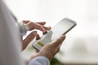 Nurse scheduling a shift using her phone using an on-demand nursing platform