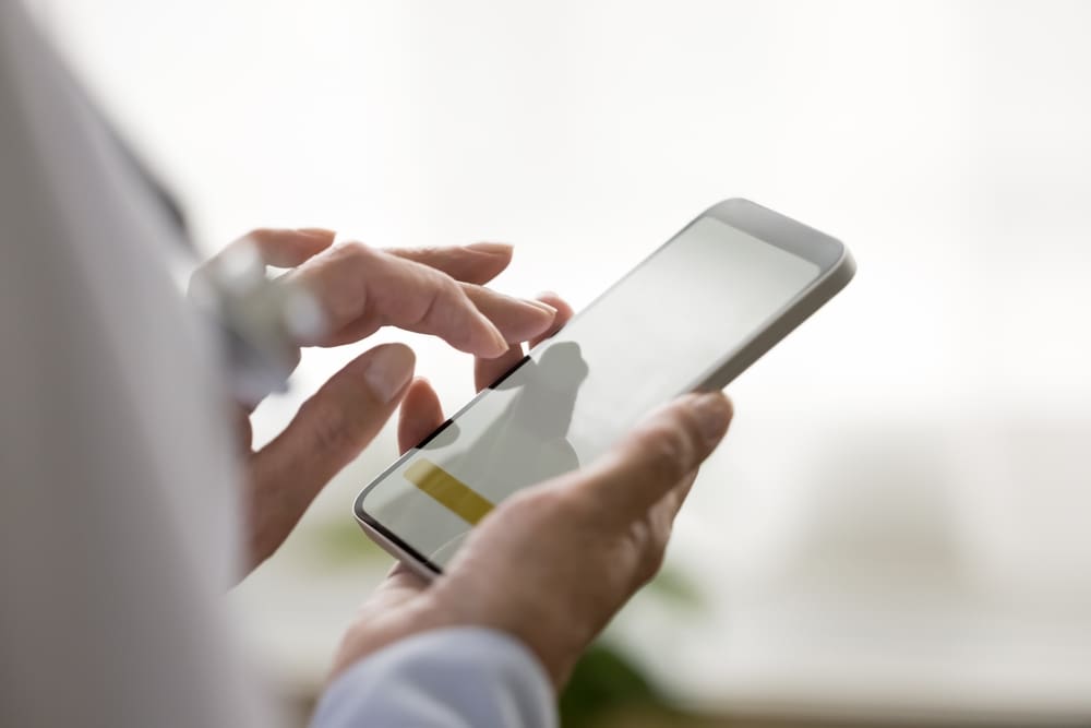 Nurse scheduling a shift using her phone using an on-demand nursing platform