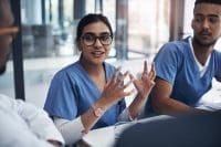 Nurse discussing domestic violence with colleagues